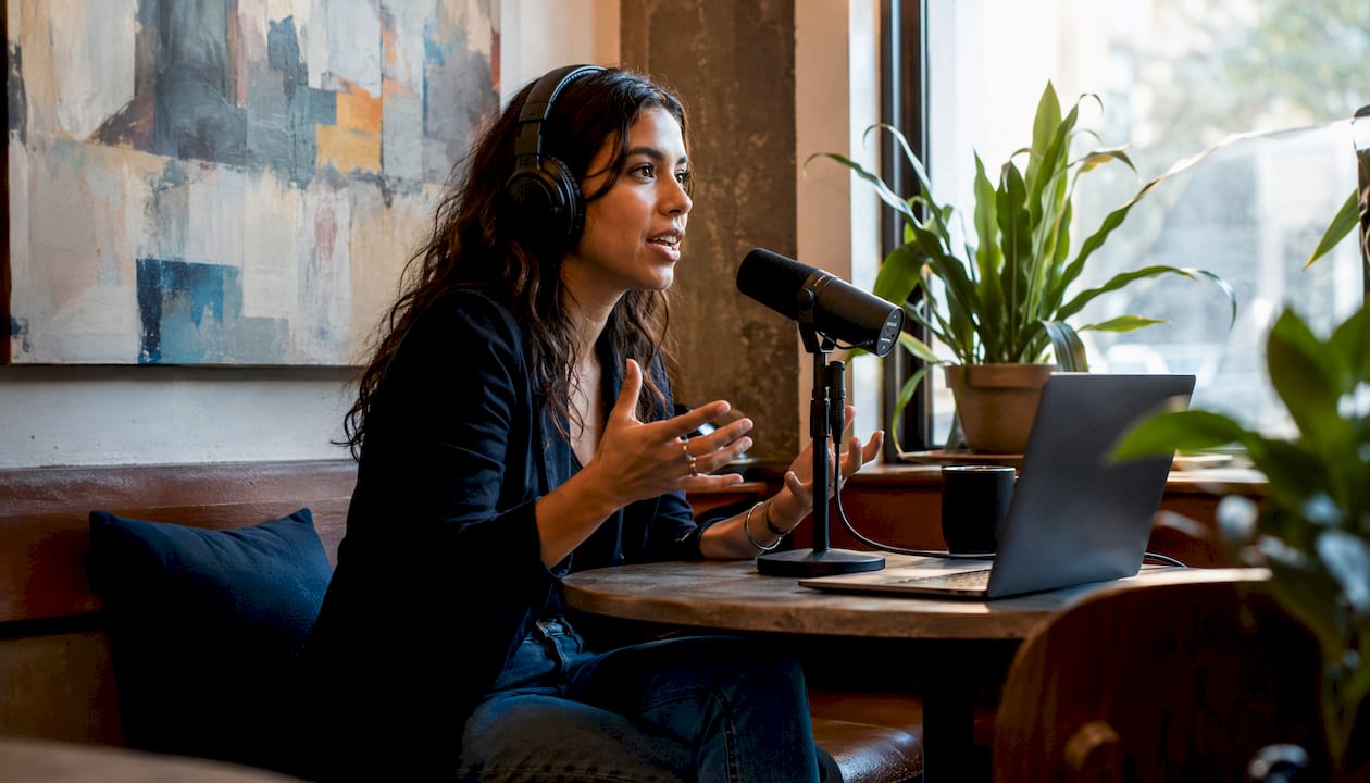 Female podcast host recording in studio