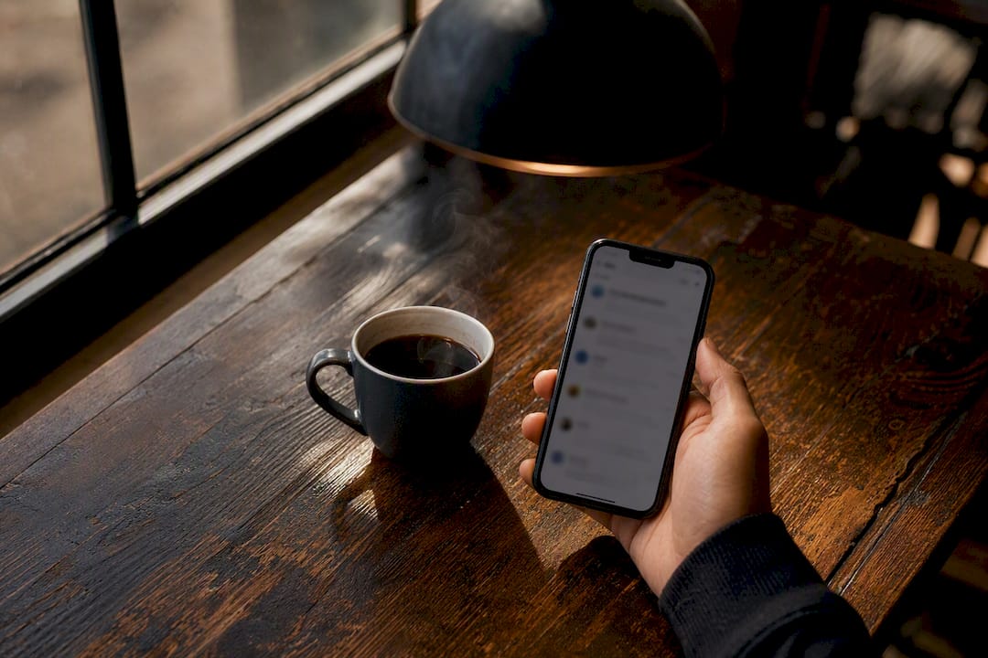 Hand holding smartphone with live chat