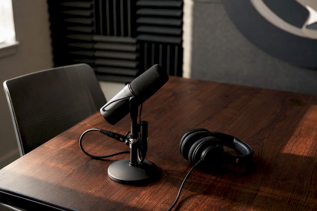 Podcast microphone and headphones on desk