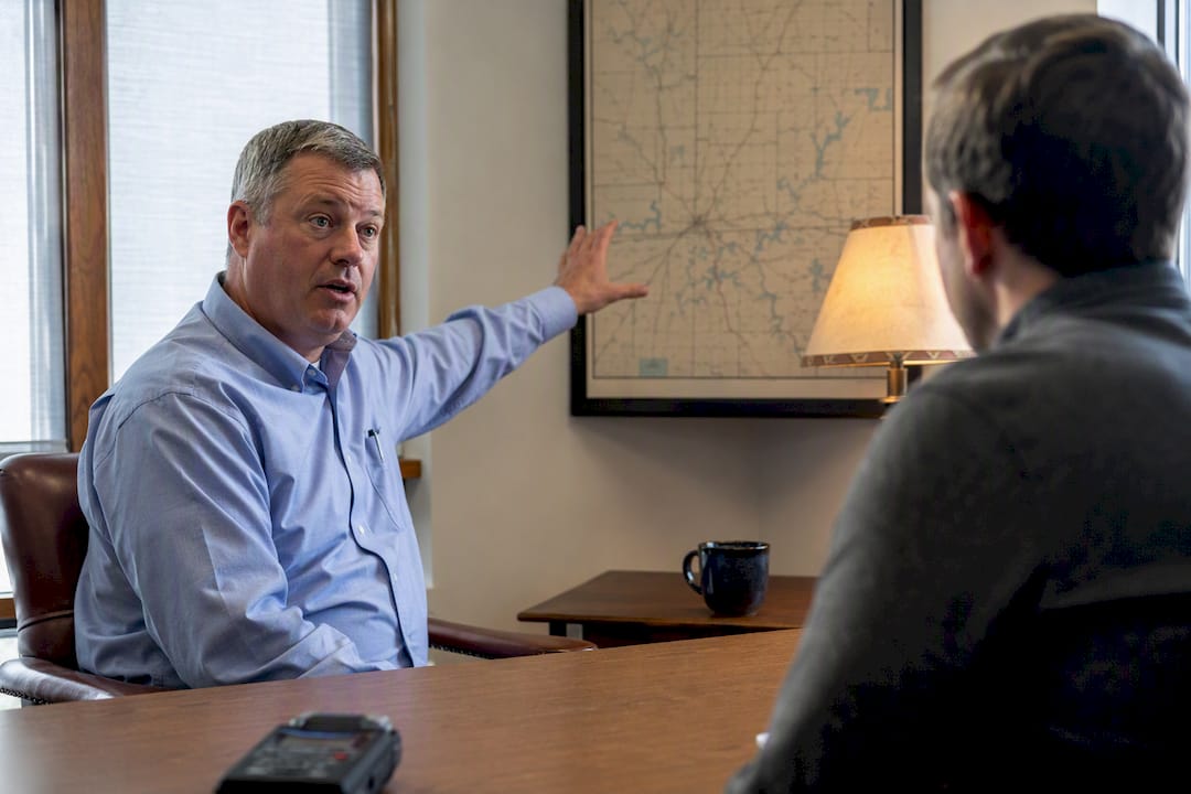 Reporter recording a rural county official interview