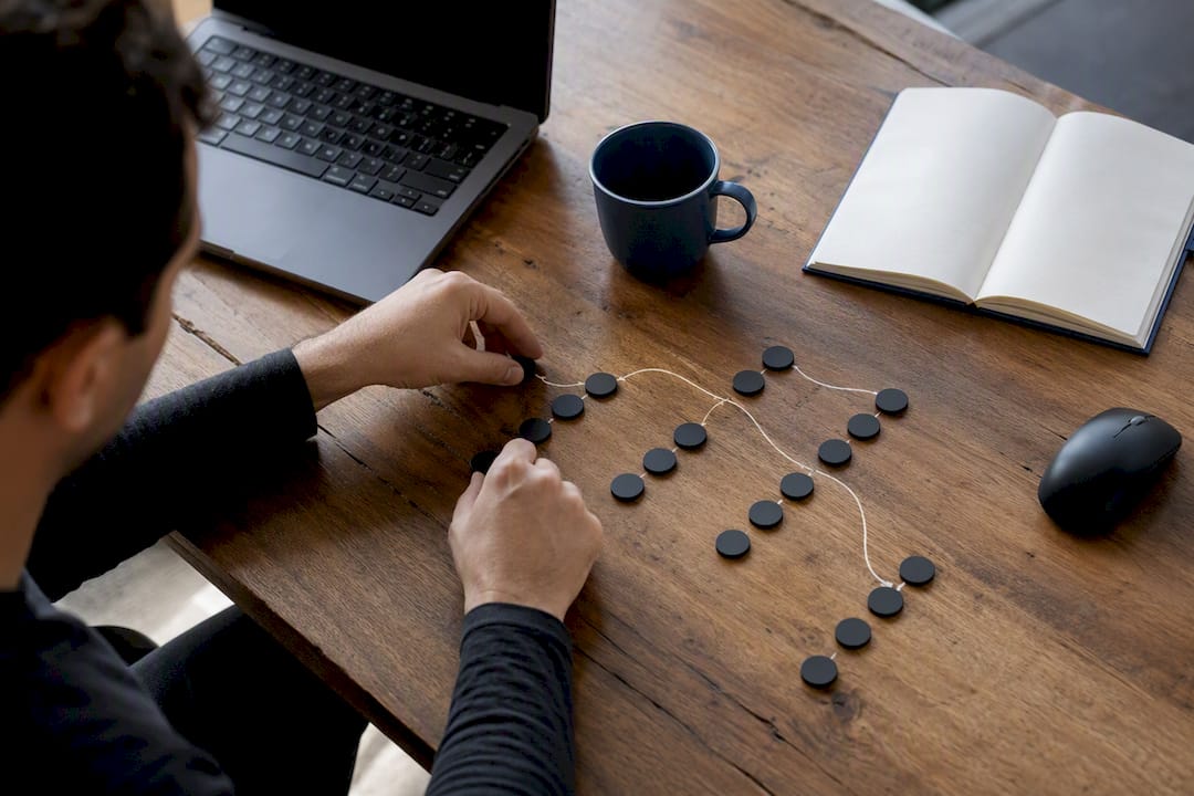Hands grouping workflow tokens on desk