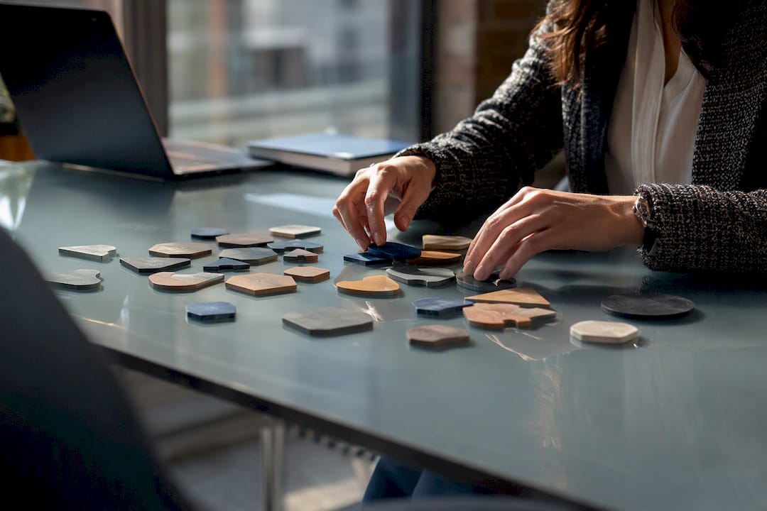 Hands sorting unique workflow tokens representing rules