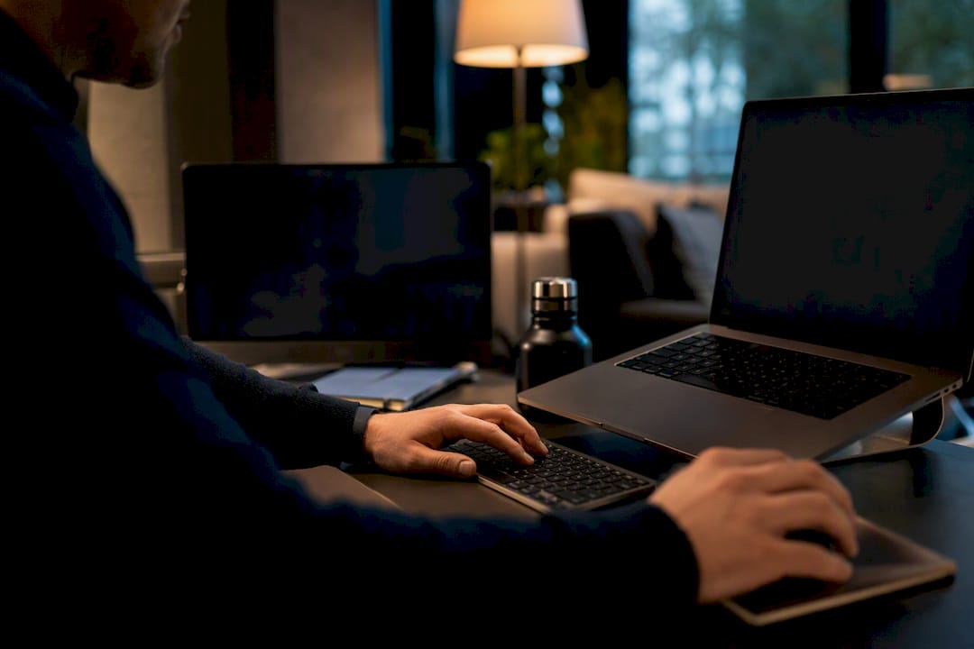 Hands monitoring workflow data on screens