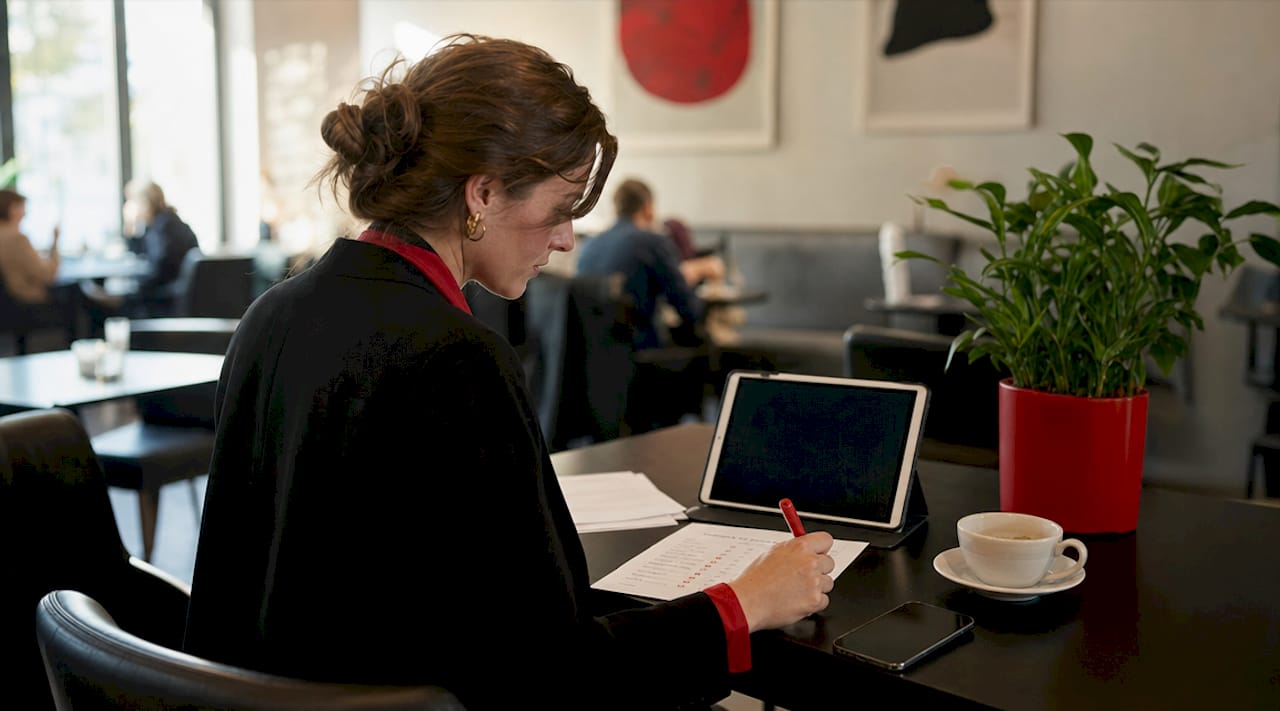 Overhead view of manager analyzing satisfaction surveys