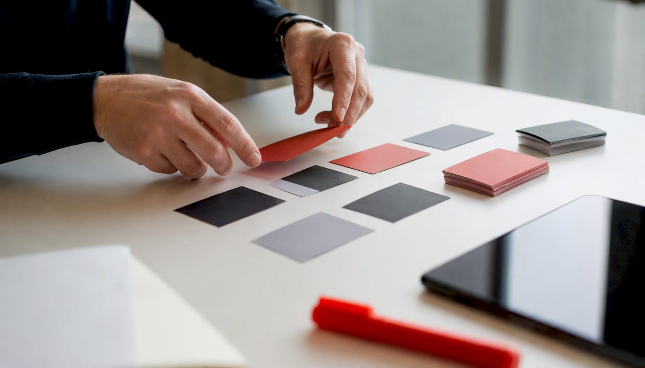 Hands sorting sales channel margin data cards