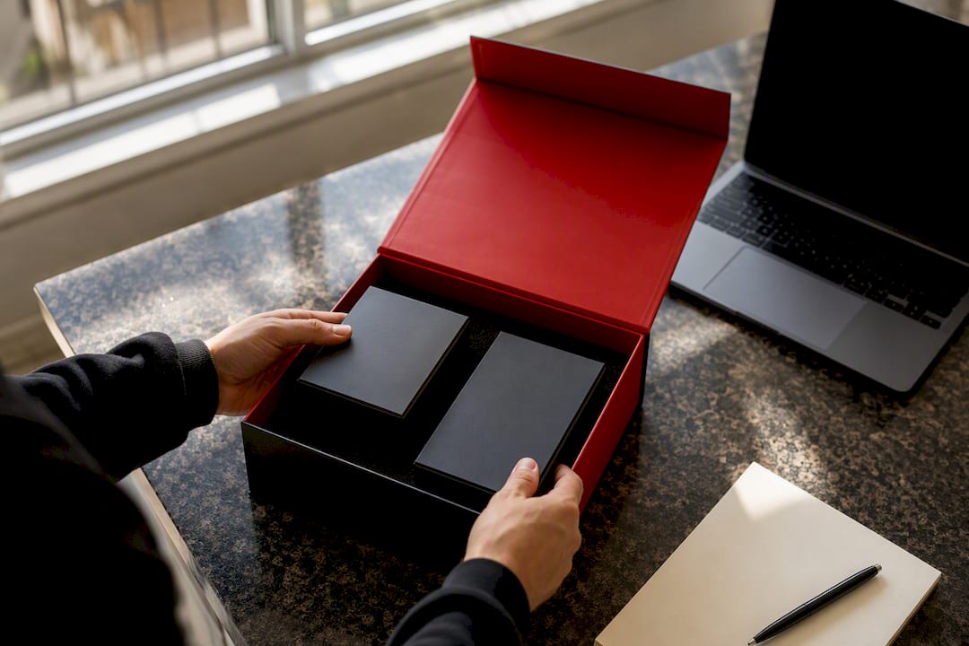 Hands assembling product bundle in box