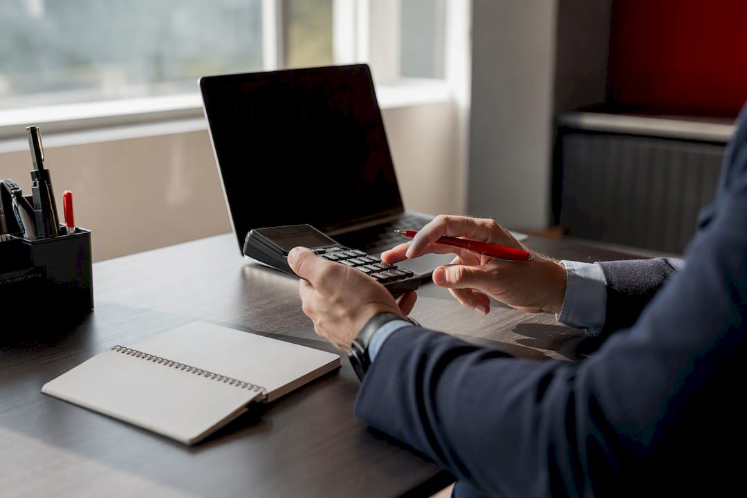 Hands calculating costs at desk
