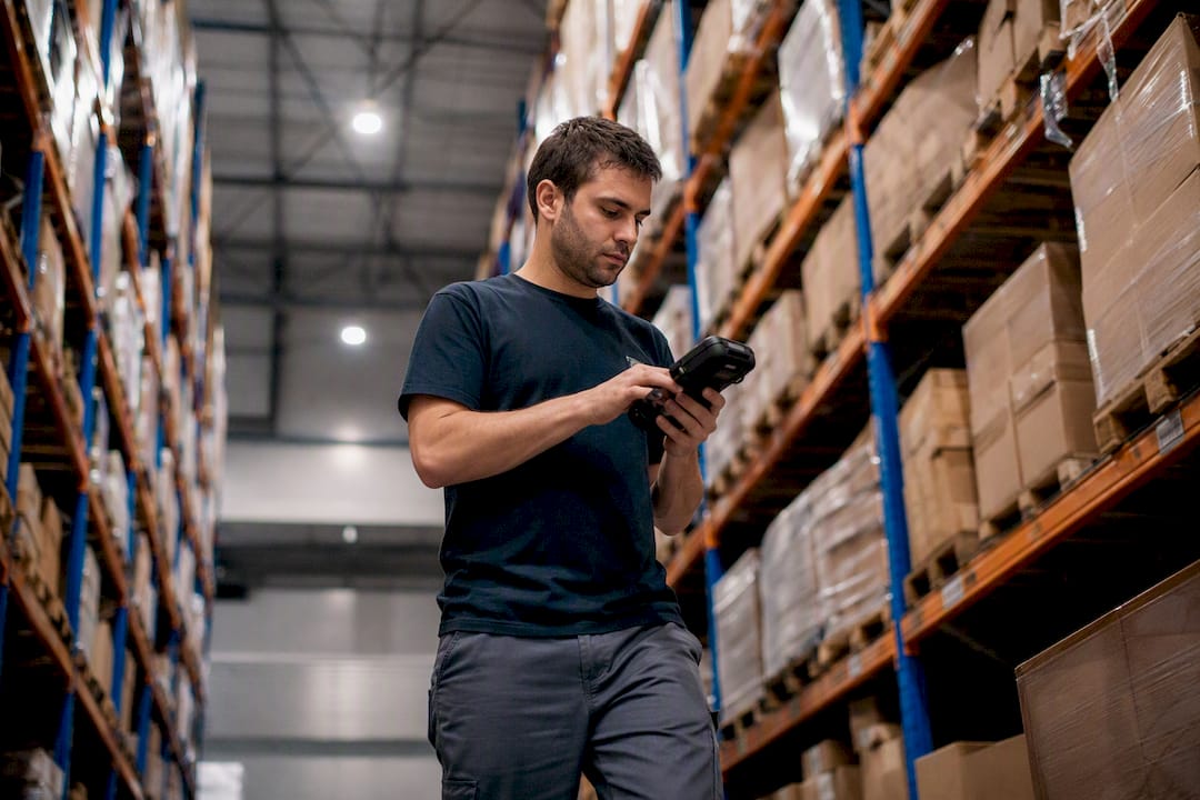 Warehouse worker updating inventory