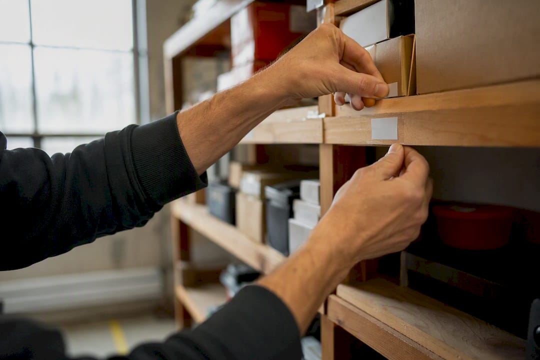 Hands adjusting warehouse inventory labels