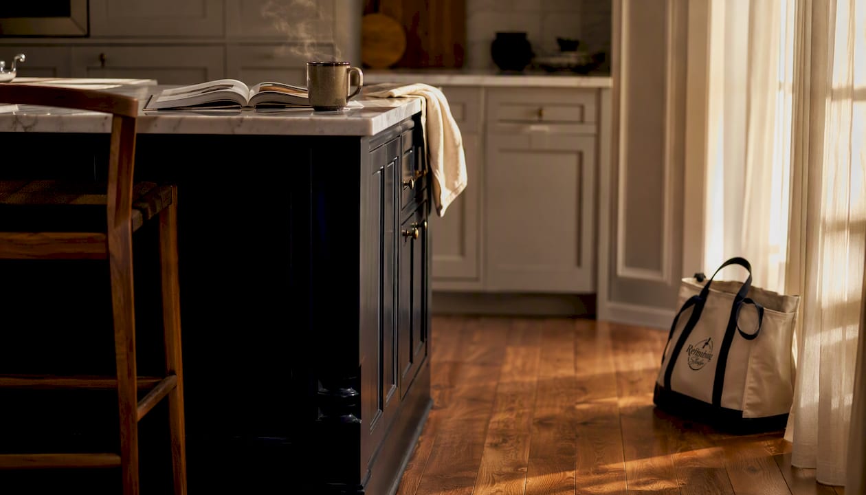 Forest green kitchen island with warm mood lighting