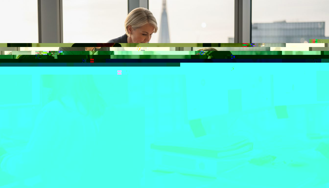 Insurance adjuster reviews digital files at desk