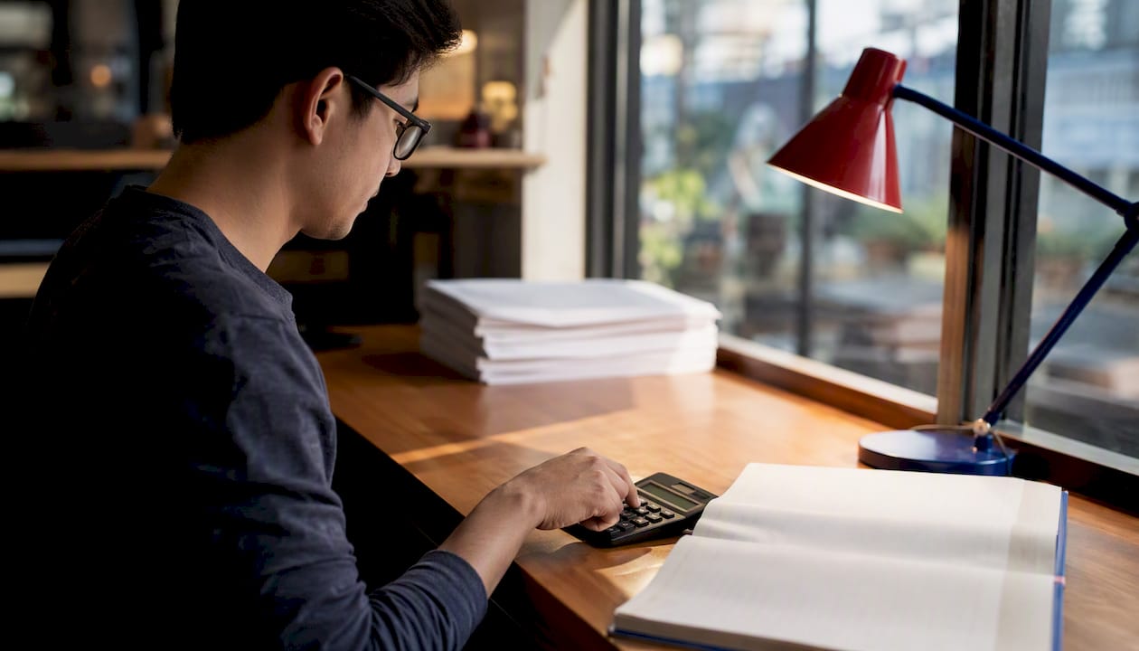 Calculator and magnifying glass on desk