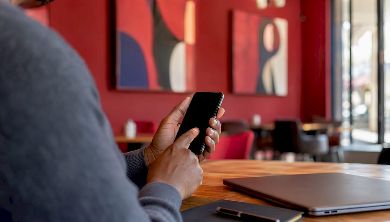 Hands holding smartphone for TIN verification