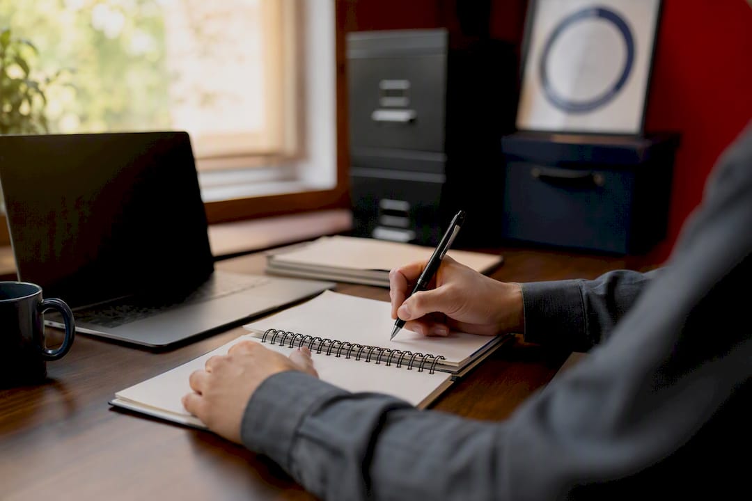 Hands with pen and audit checklist on desk