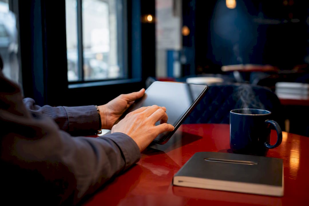 Hands uploading vendor data on tablet