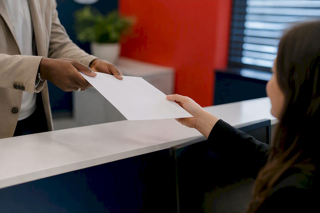 Hands exchanging W-9 form