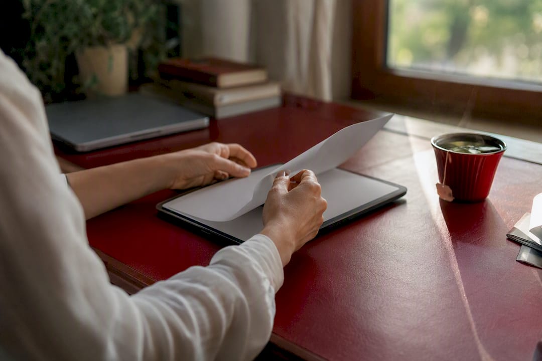 Hands using calculator in small business workspace