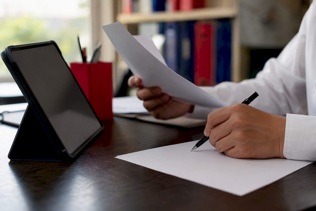 Hands verifying tax ID numbers for accuracy