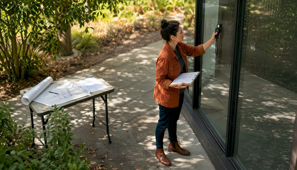 Architect measuring daylight at residential building
