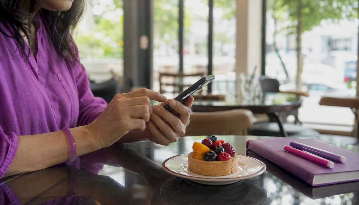 Close-up of hands using finance app on smartphone