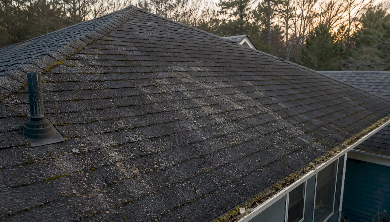 Weathered roof shingles with granular loss