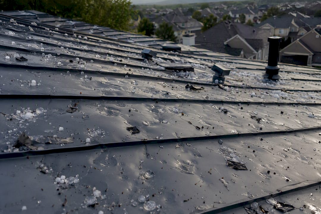 Storm damaged dents on metal roof panels