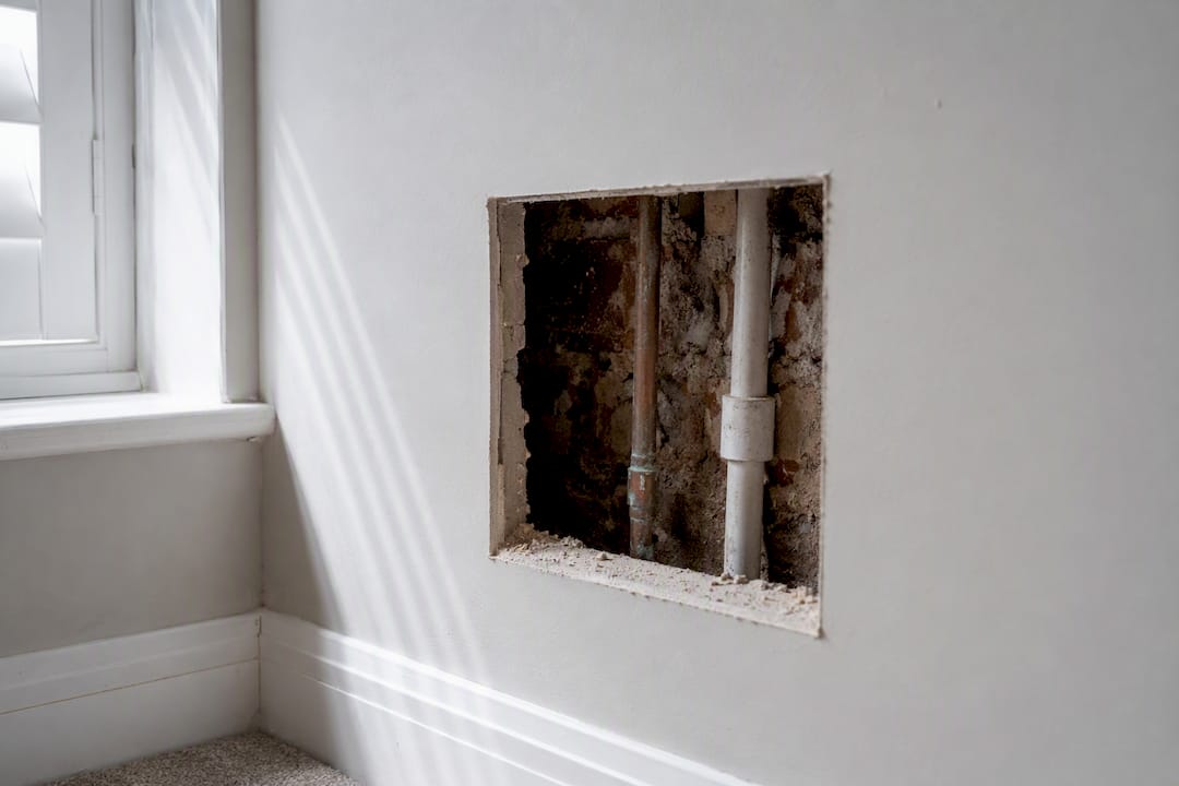 Neat wall access hole after leak investigation