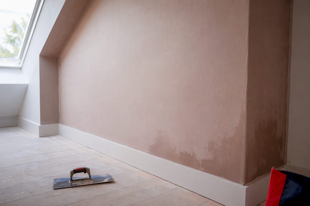 Pale and darker patches on drying plaster