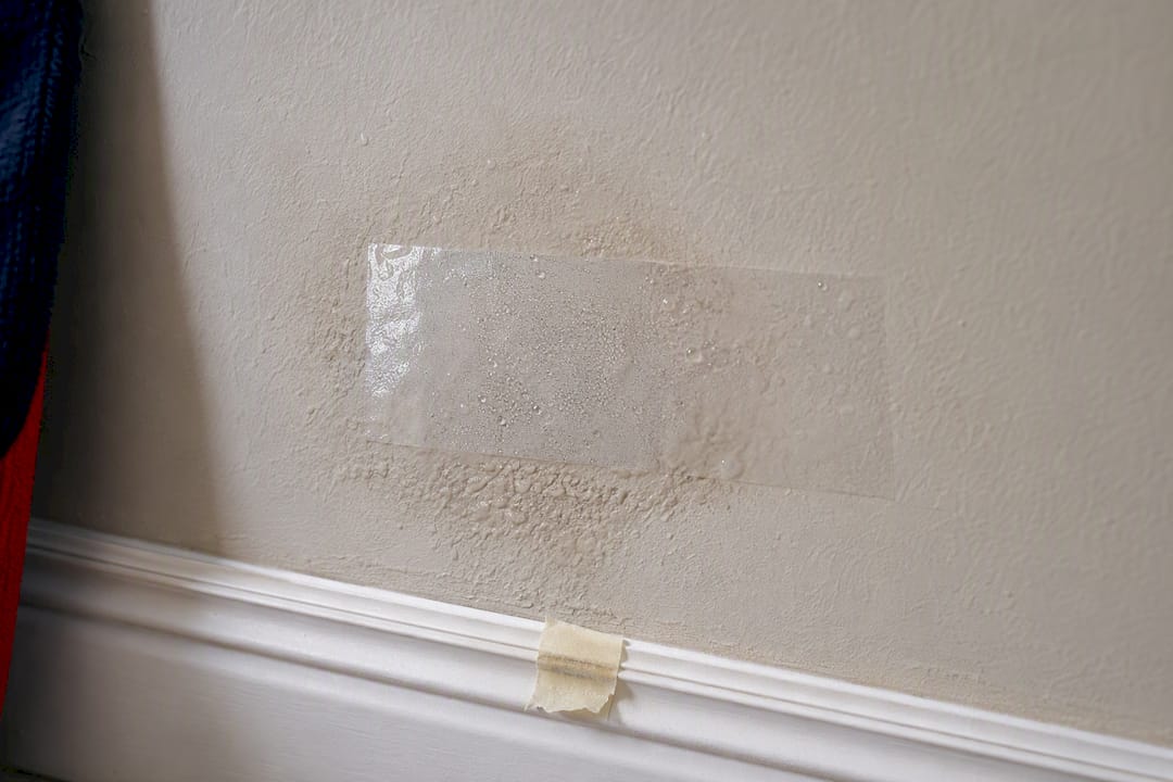 Transparent tape test on damp plaster wall