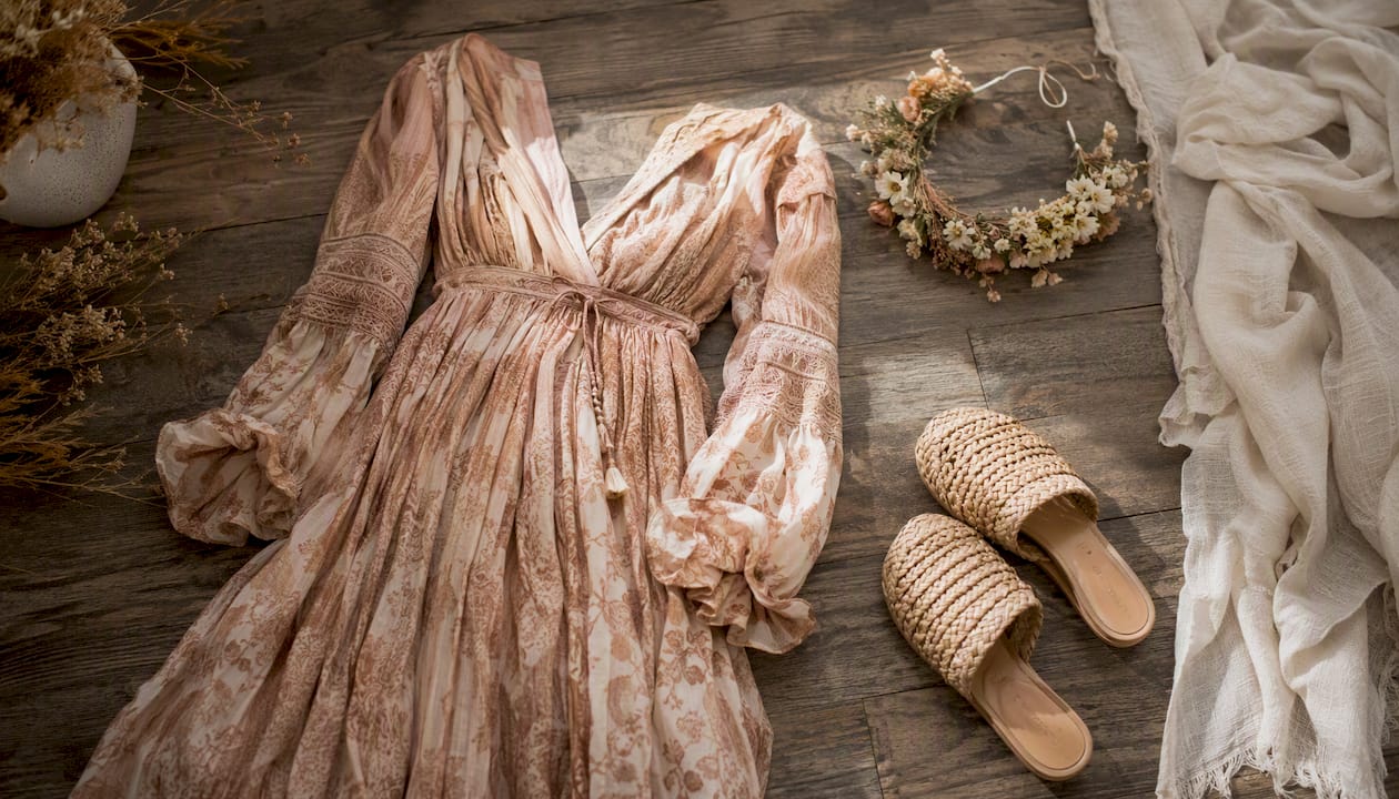 Boho style maternity dress with natural accessories flat lay