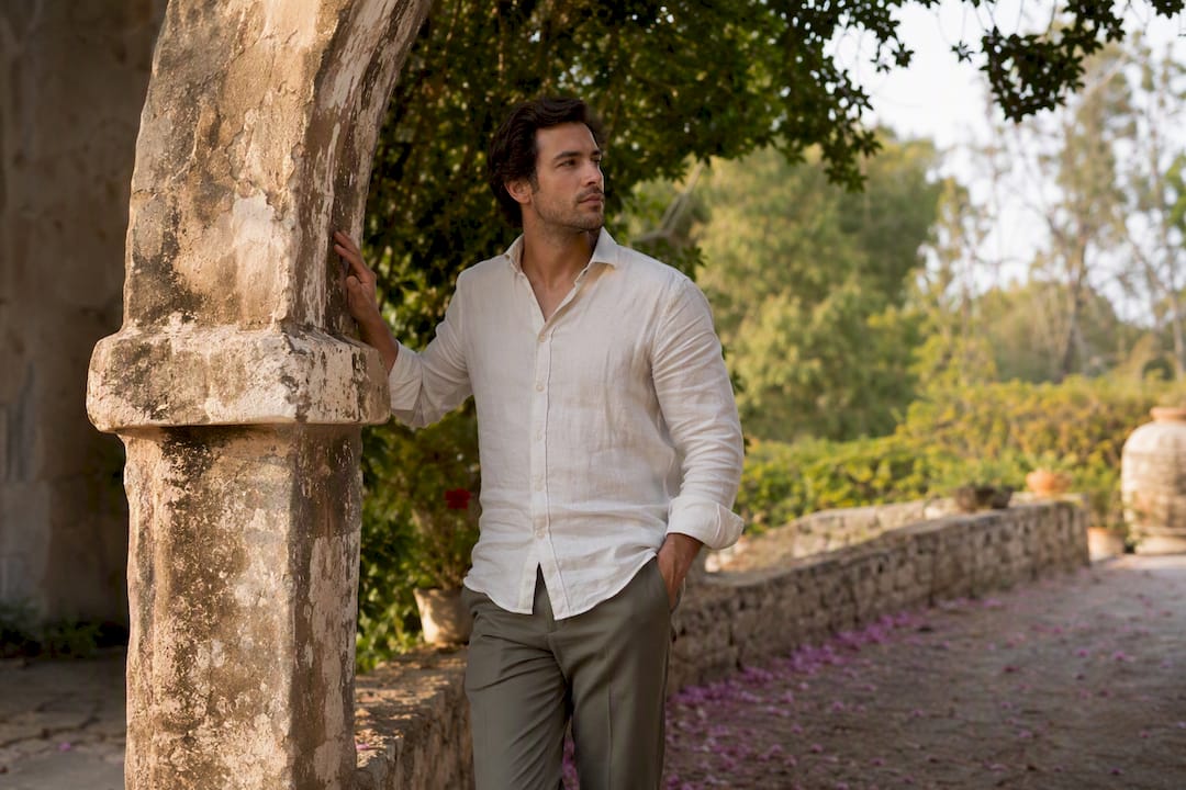 Man posing using rustic archway support