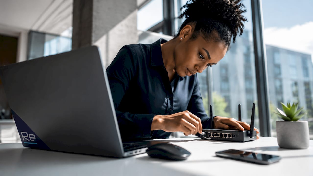 IT specialist hands configuring SD-WAN at desk