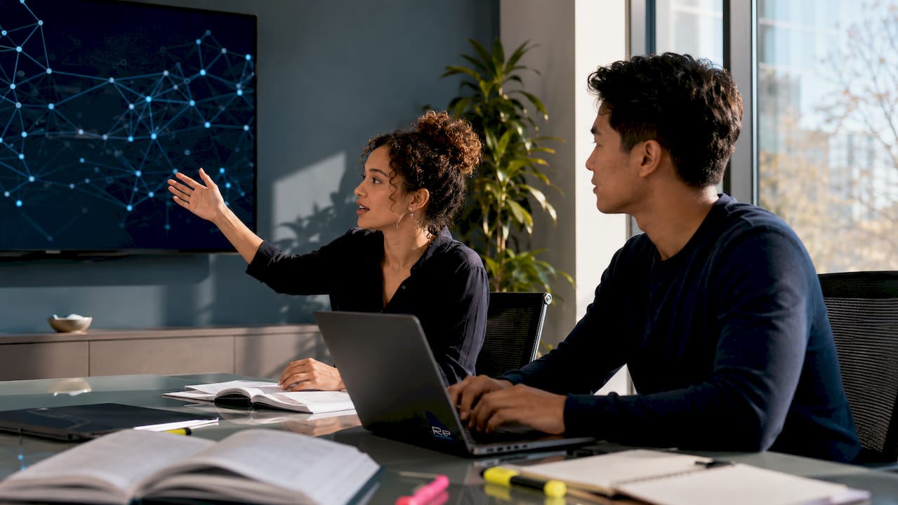 Two IT specialists collaborating on network planning