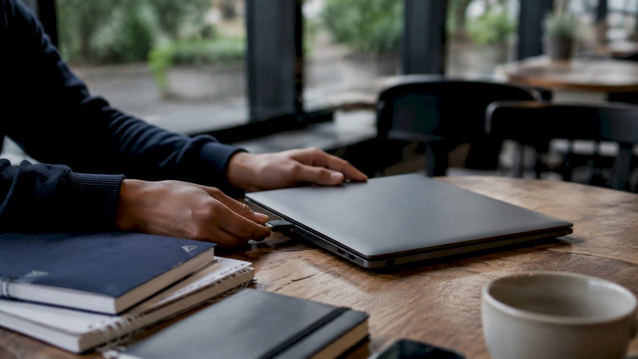 Advantages of cloud backup in education: 2026 guide - Re-solution Student backing up data using laptop and USB drive