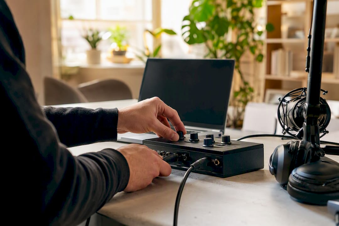 Hands adjusting audio streaming device controls