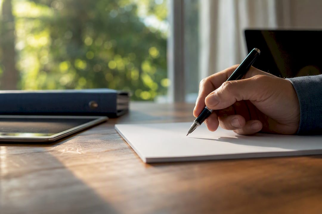 Hand poised to sign real estate contract