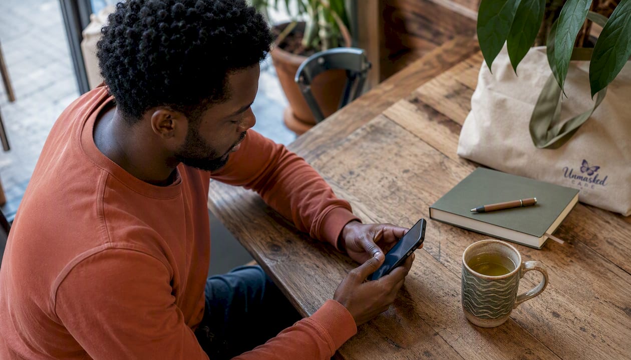 Man reading message thoughtfully in kitchen