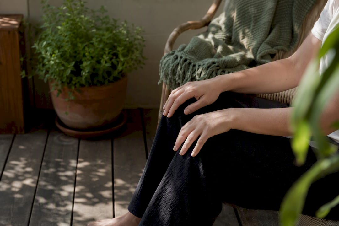 Hands resting on abdomen in mindful breathing