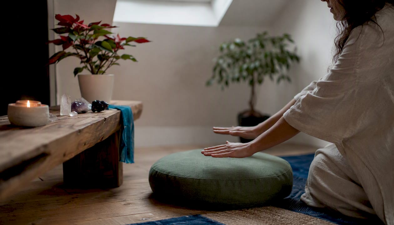 Hands performing energy healing in calm room