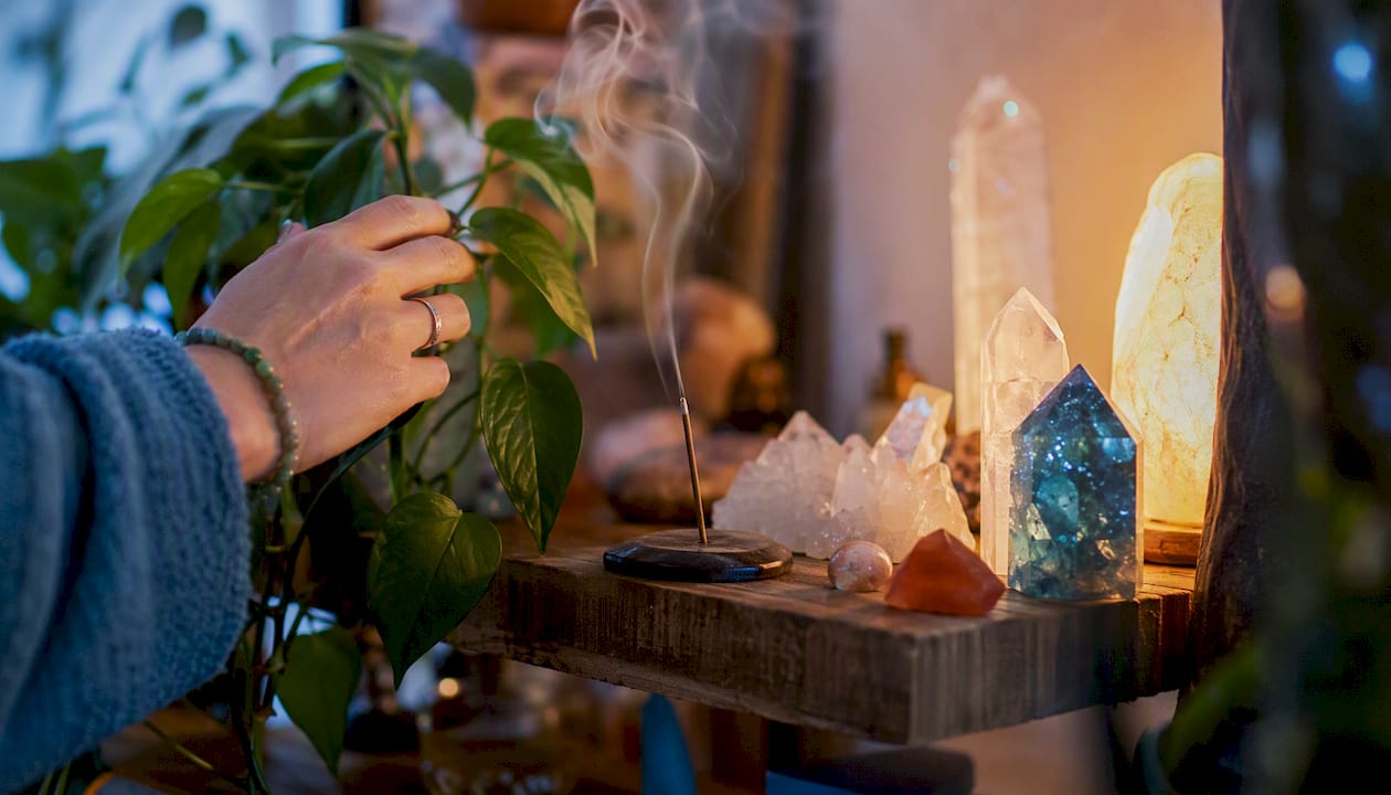Healing crystals and leaves on wooden table