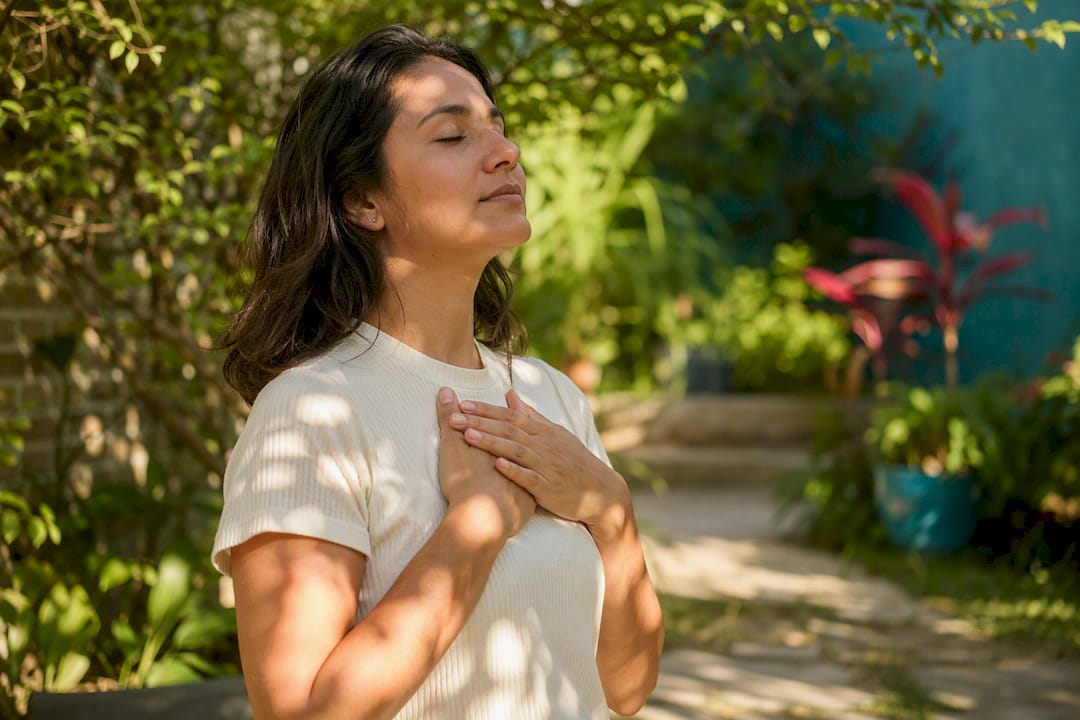 Hands resting on chest during mindful breathing