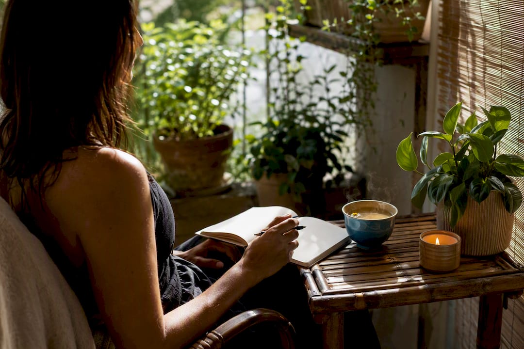 Notebook, pen and tea for shadow work journaling