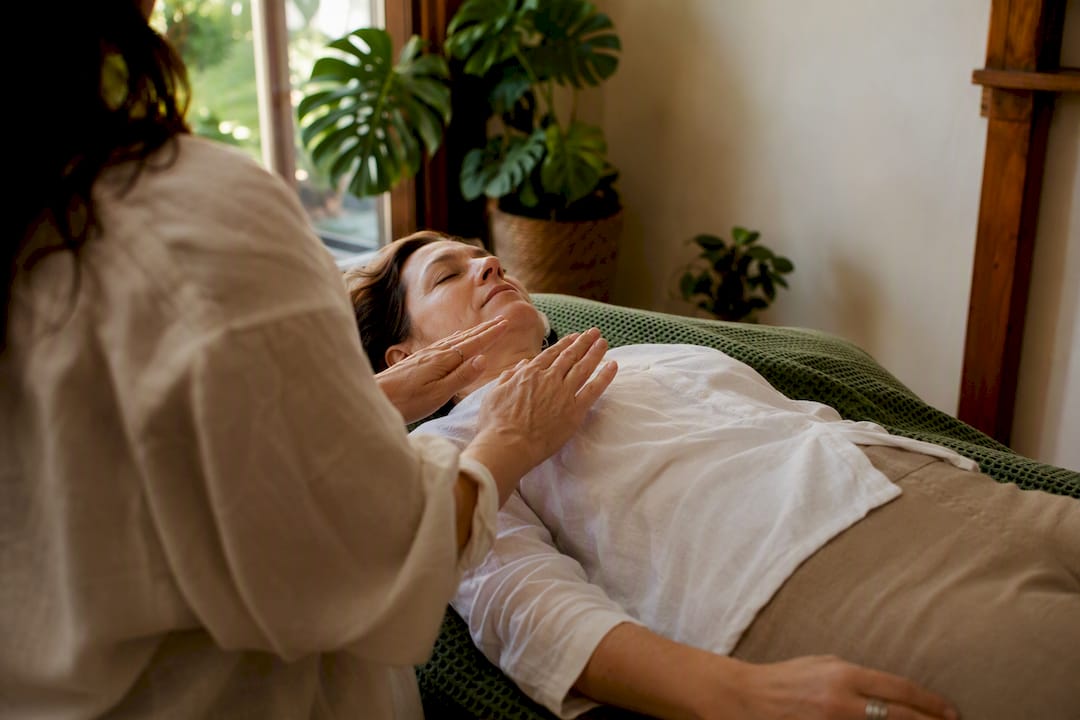 Hands performing energy healing over chest