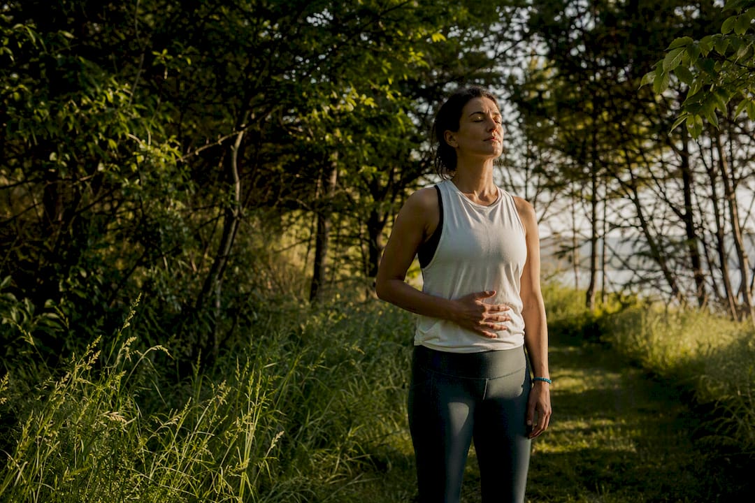 Person practicing grounding breath outdoors