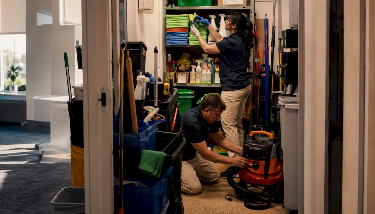 Janitorial crew organizing cleaning supplies