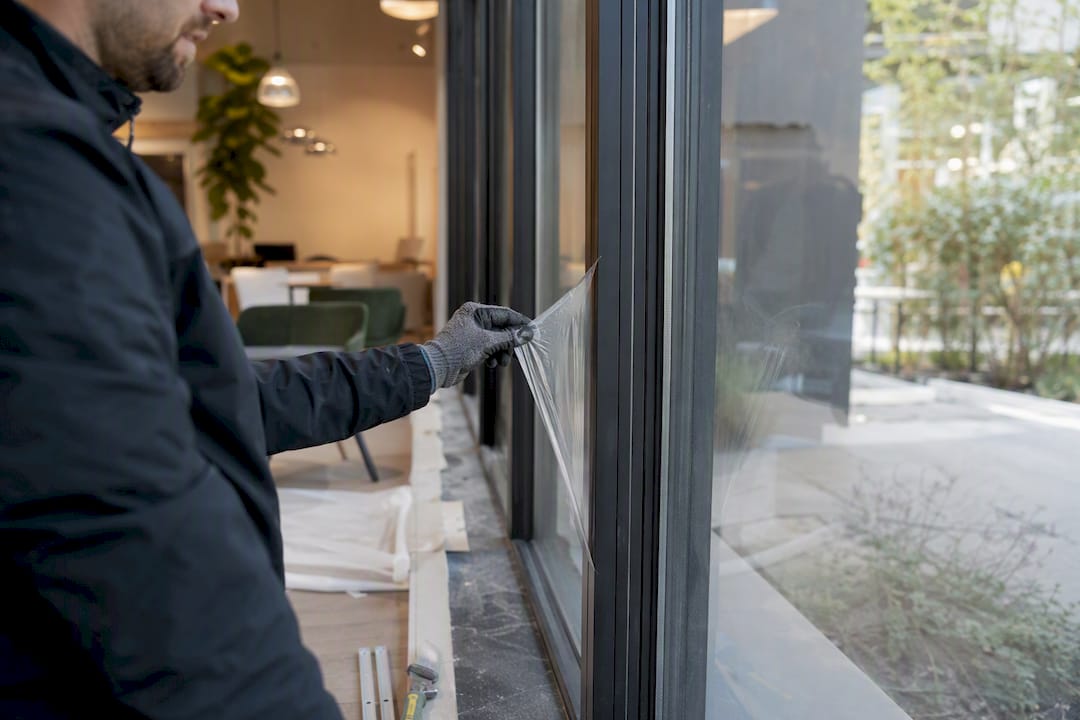 Gloved hand removing protective film on site walk