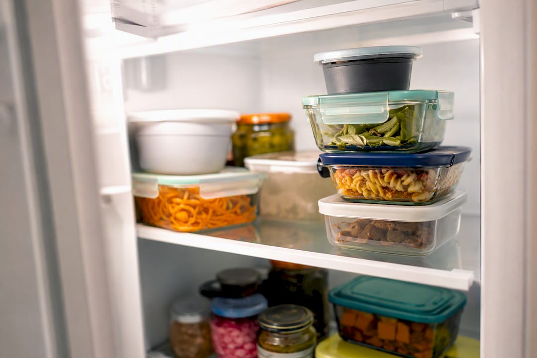 Labeled food containers in office fridge