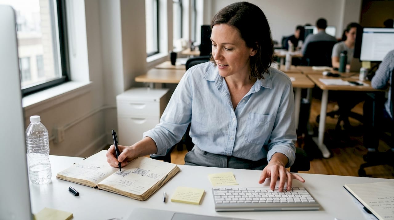 Worker organizing day with time-blocking planner