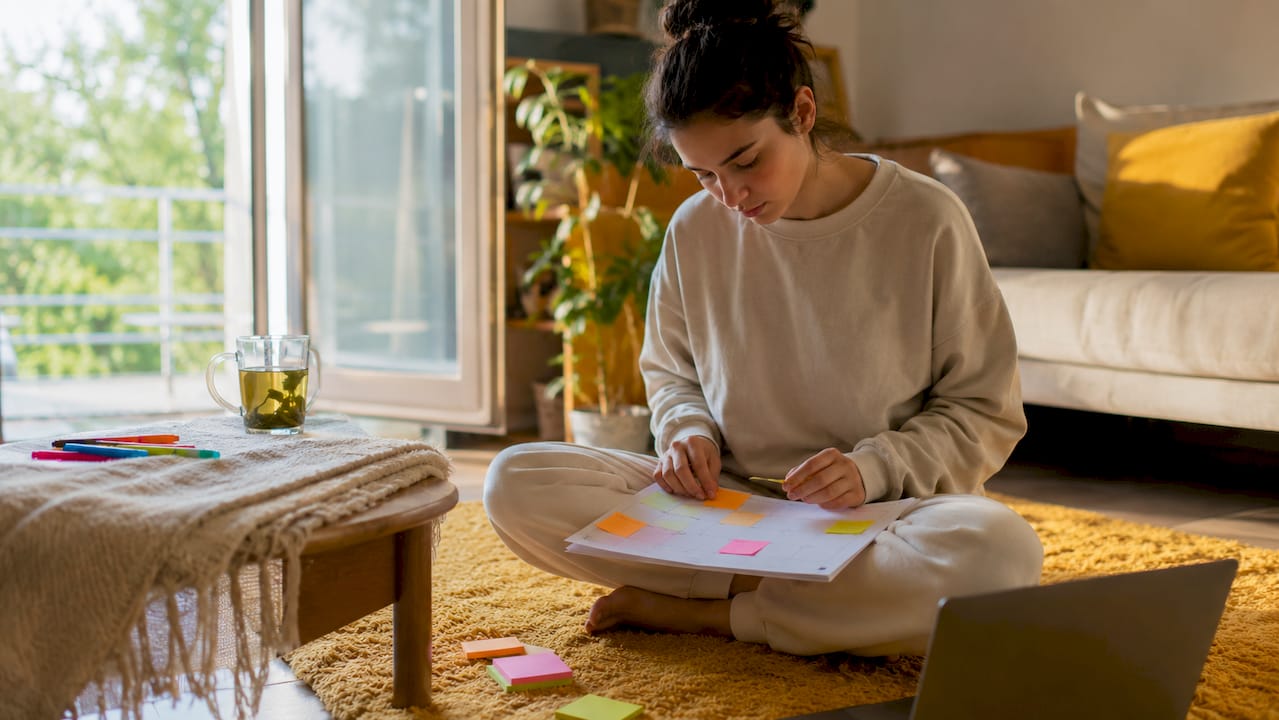Student organizing study schedule at home