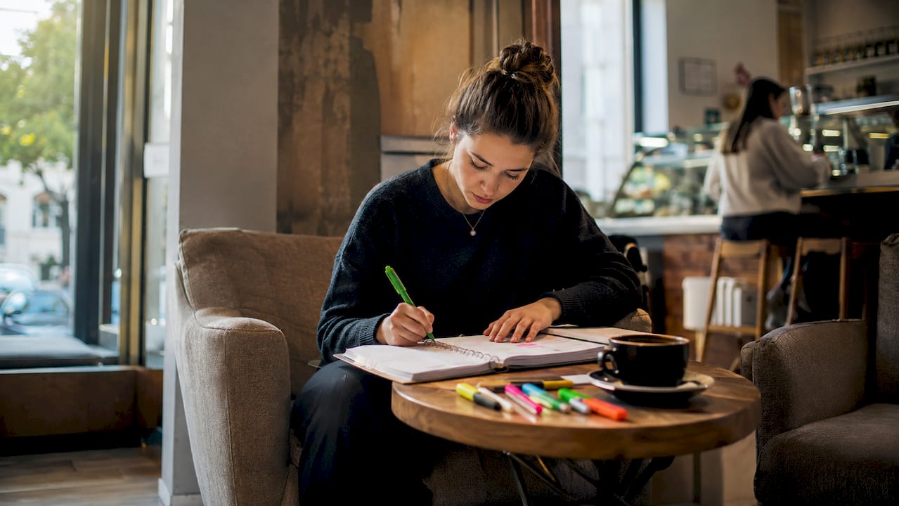 Student writing short term goals in planner